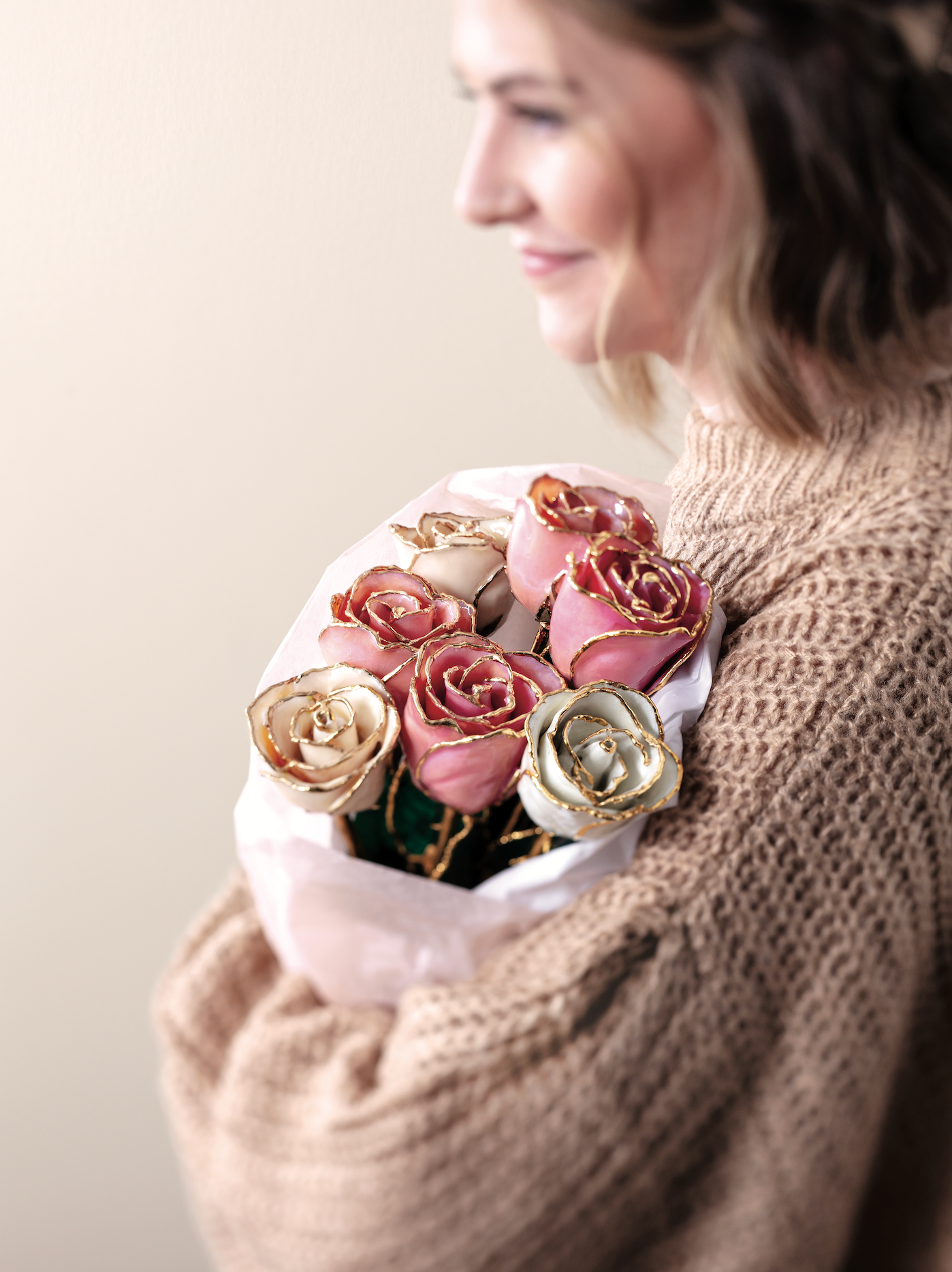Woman holding a 24K gold trimmed preserved rose – thoughtful romantic gift from Couture Jewelry NYC