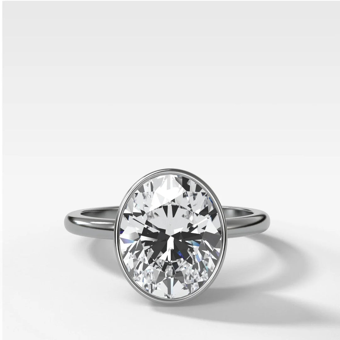 14k white gold bezel set oval diamond engagement ring, modern minimalist design with 2.50ct lab stone