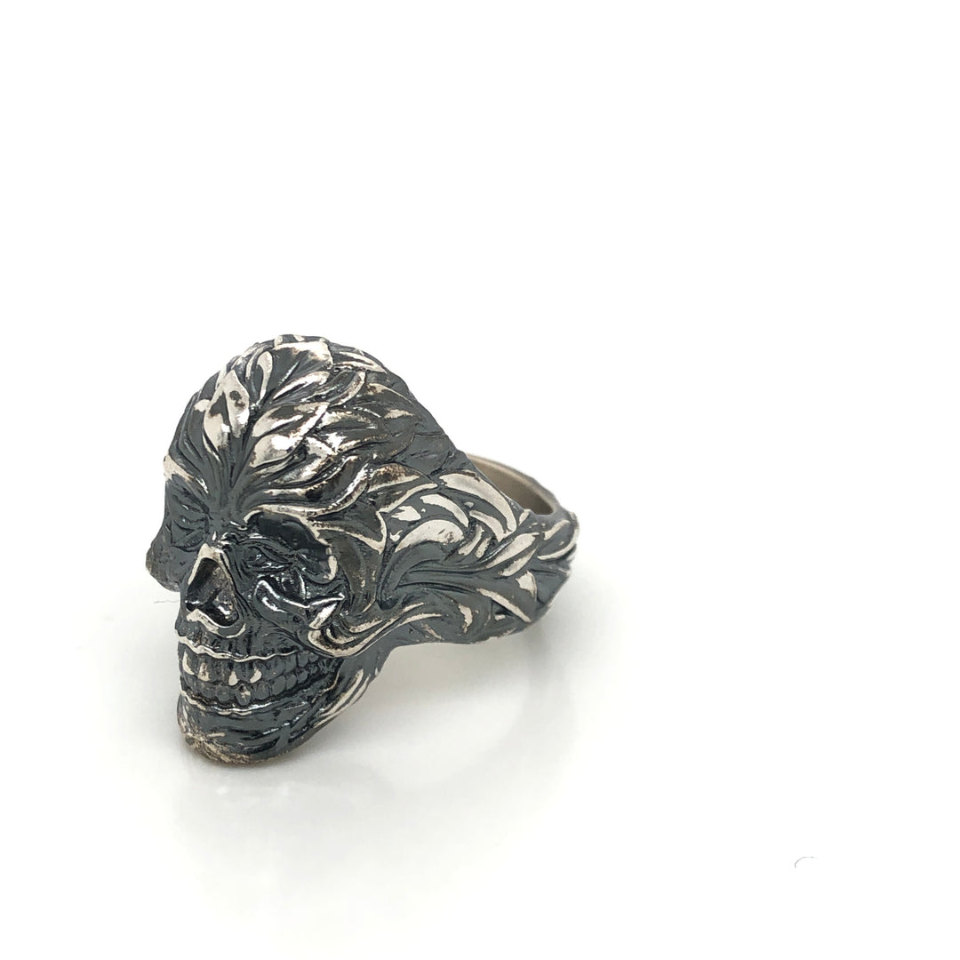 Sculptural sterling silver skull ring with black oxidized floral relief carvings