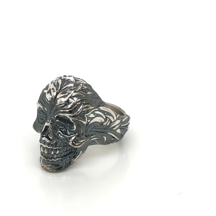 Sculptural sterling silver skull ring with black oxidized floral relief carvings