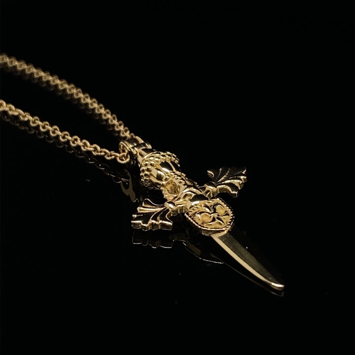 Solid 18K yellow gold dagger pendant with sculptural detail